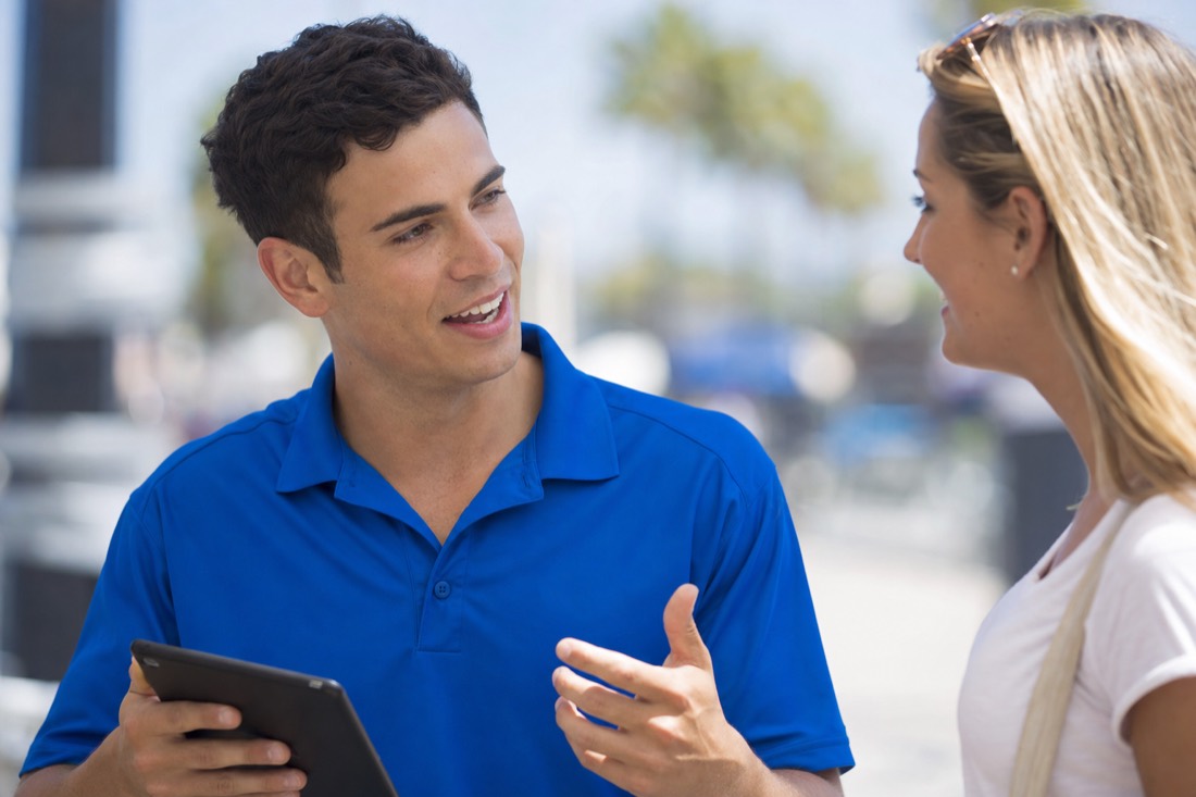 A Square One Enterprise brand ambassador having a friendly face-to-face conversation with a customer
